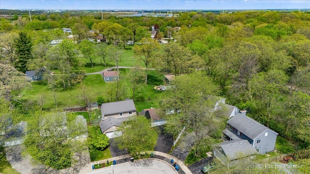 view of property location with a forest