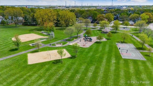 view of property's community featuring community basketball court and a yard