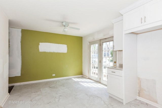 563 Lynn Ct Unit A, Glendale Heights, IL 60139 - unfurnished dining area with ceiling fan, baseboards, french doors, and light marble finish floors