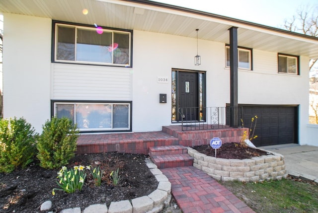 view of front of home with a garage, covered porch, and concrete driveway