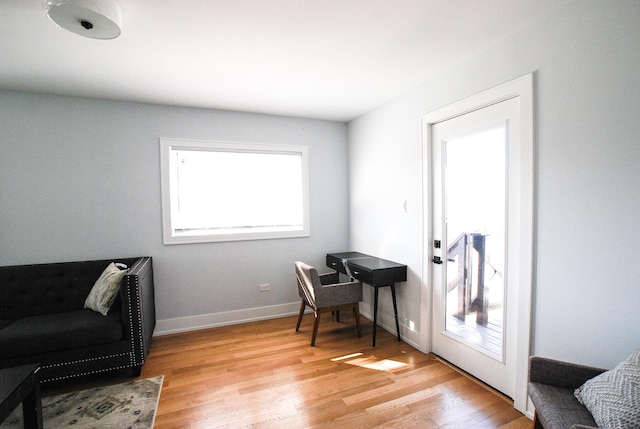 office space featuring light wood-type flooring and baseboards