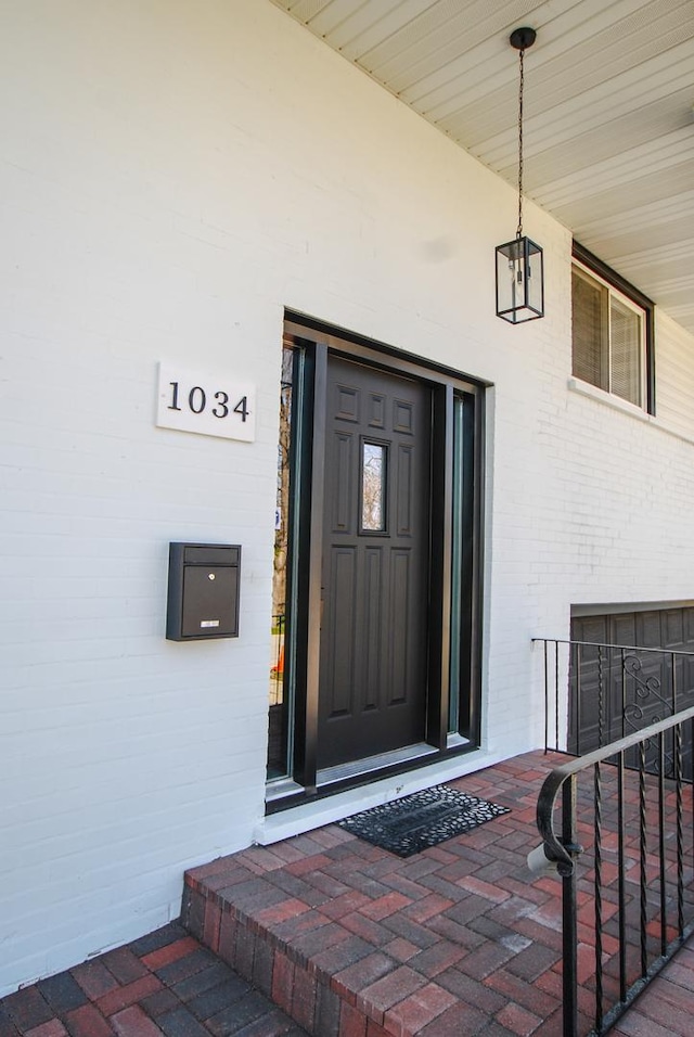 entrance to property featuring brick siding