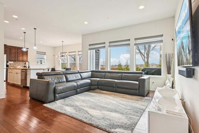 living area featuring recessed lighting, dark wood-style flooring, and a chandelier