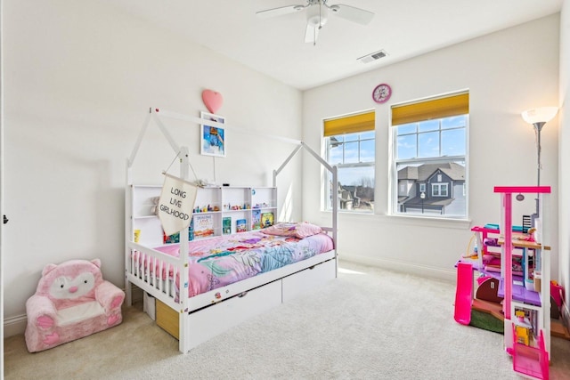 carpeted bedroom featuring baseboards and a ceiling fan