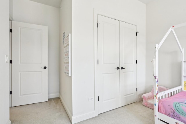 bedroom with carpet flooring, a closet, and baseboards