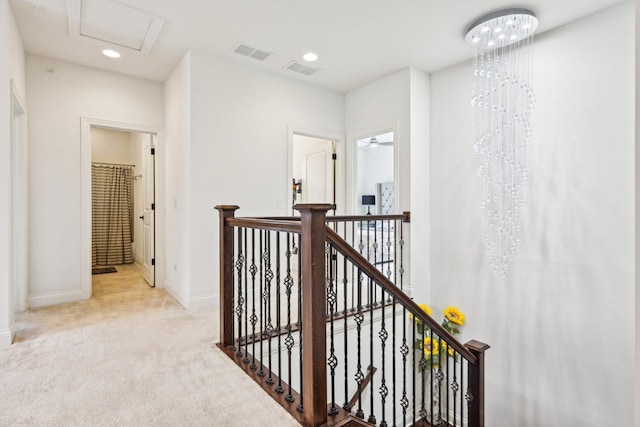 hall featuring an upstairs landing, carpet, baseboards, and recessed lighting