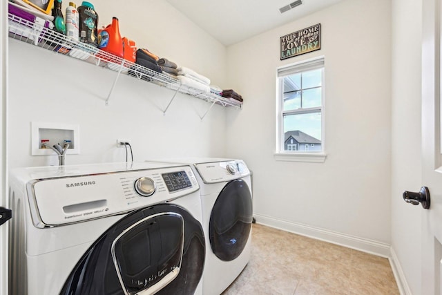 laundry area featuring washer and clothes dryer and baseboards