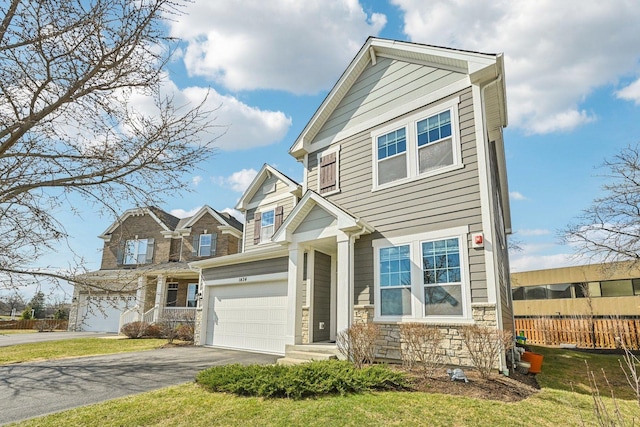 craftsman house featuring asphalt driveway, stone siding, and a garage