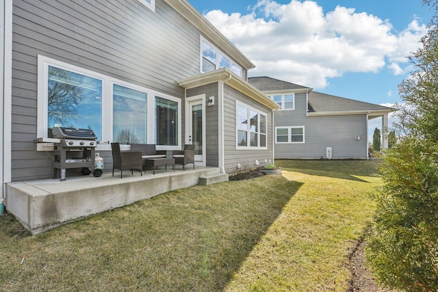 rear view of property with a yard, a patio, and an outdoor living space