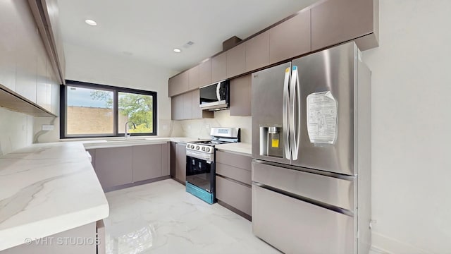 6330 Hennings Ct, Morton Grove, IL 60053 - kitchen featuring stainless steel appliances, gray cabinetry, light marble finish flooring, a sink, and light stone countertops