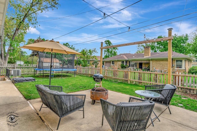 view of patio featuring a fire pit and a trampoline
