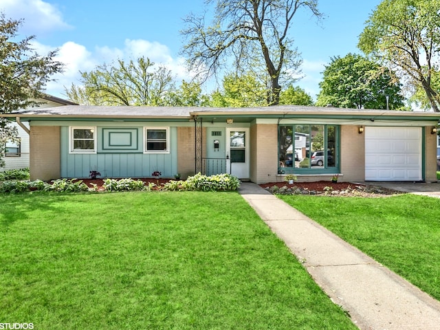 1011 Beverly Dr, Wheeling, IL 60090 - view of front of house with brick siding, a garage, board and batten siding, a front yard, and driveway