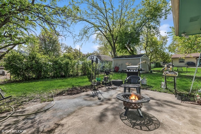 1011 Beverly Dr, Wheeling, IL 60090 - view of patio / terrace featuring an outdoor fire pit, a storage unit, an outbuilding, and area for grilling