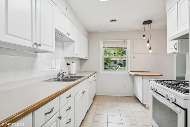 1011 Beverly Dr, Wheeling, IL 60090 - kitchen featuring white gas range, a sink, tasteful backsplash, and white cabinetry