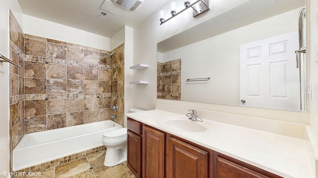 full bathroom featuring toilet, vanity, and washtub / shower combination