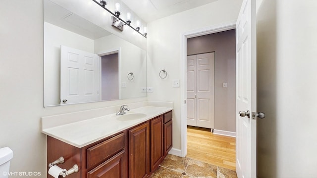 half bathroom with vanity and toilet