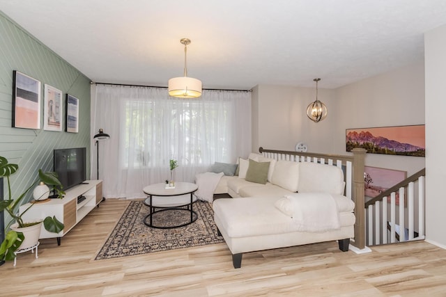 living area featuring wood finished floors and a chandelier