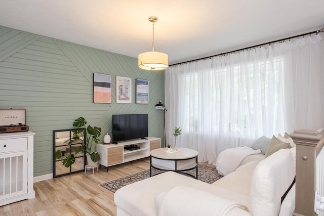 living area featuring light wood finished floors and baseboards