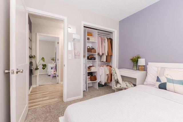 bedroom with light carpet and baseboards