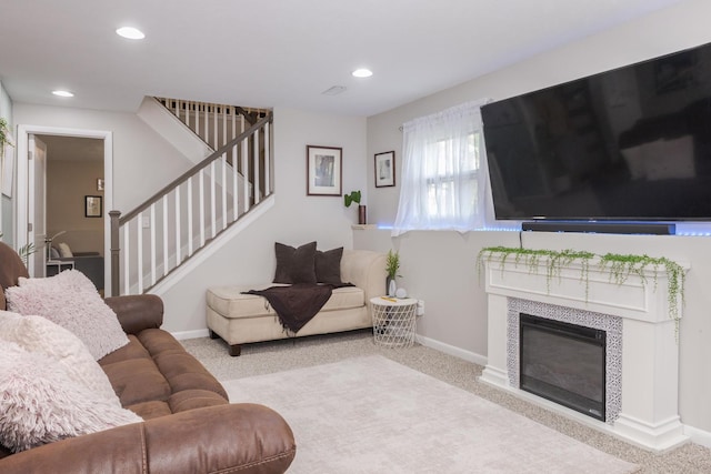 carpeted living room featuring stairs, a fireplace, baseboards, and recessed lighting