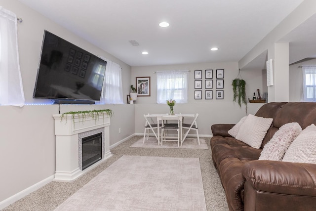 living room with carpet flooring, recessed lighting, baseboards, and a fireplace