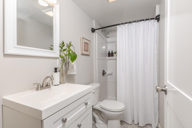 bathroom featuring toilet, a textured ceiling, a shower with shower curtain, and vanity
