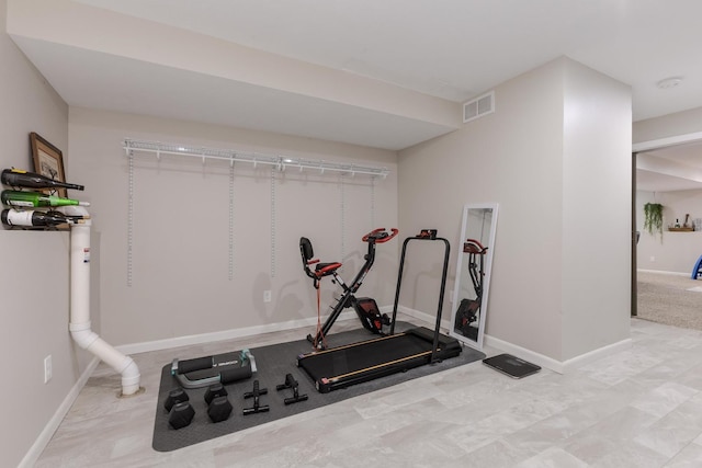 workout room featuring baseboards
