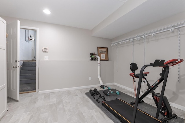 exercise room with recessed lighting and baseboards