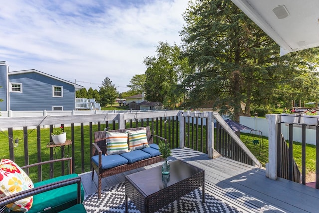 wooden deck with a lawn and an outdoor living space