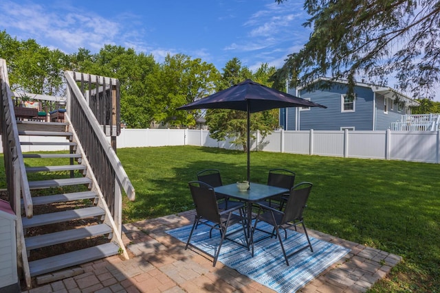 view of patio featuring stairs, outdoor dining space, and a deck