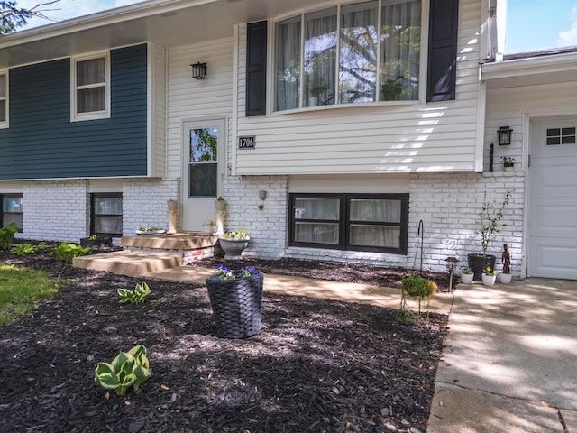 doorway to property featuring brick siding