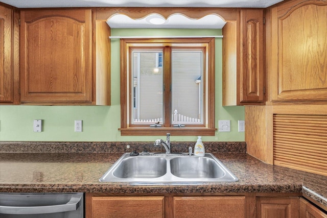 123 E 14th St, Gibson City, IL 60936 - kitchen featuring a sink, stainless steel dishwasher, dark countertops, and brown cabinets