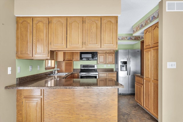 123 E 14th St, Gibson City, IL 60936 - kitchen with appliances with stainless steel finishes, a peninsula, and a sink