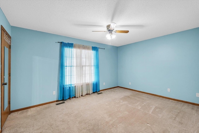 123 E 14th St, Gibson City, IL 60936 - carpeted spare room with ceiling fan, a textured ceiling, and baseboards