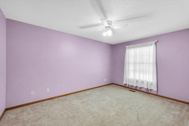 123 E 14th St, Gibson City, IL 60936 - carpeted empty room featuring a ceiling fan, baseboards, and a textured ceiling