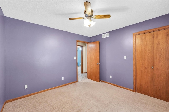 123 E 14th St, Gibson City, IL 60936 - unfurnished bedroom with carpet, baseboards, a closet, and ceiling fan