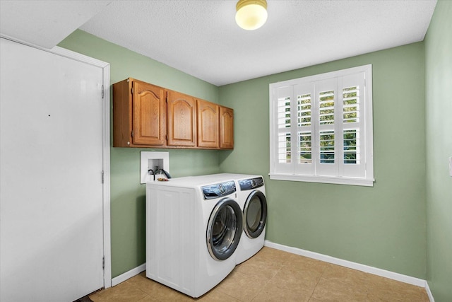 123 E 14th St, Gibson City, IL 60936 - laundry room featuring separate washer and dryer, cabinet space, baseboards, a textured ceiling, and light tile patterned floors