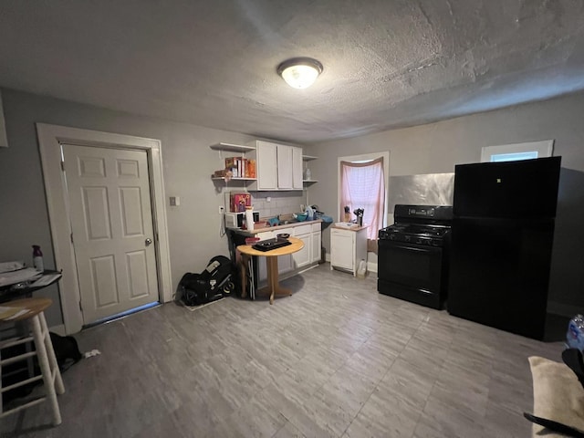 307 S 4th Ave, Kankakee, IL 60901 - kitchen featuring black appliances, open shelves, white cabinetry, a textured ceiling, and light countertops