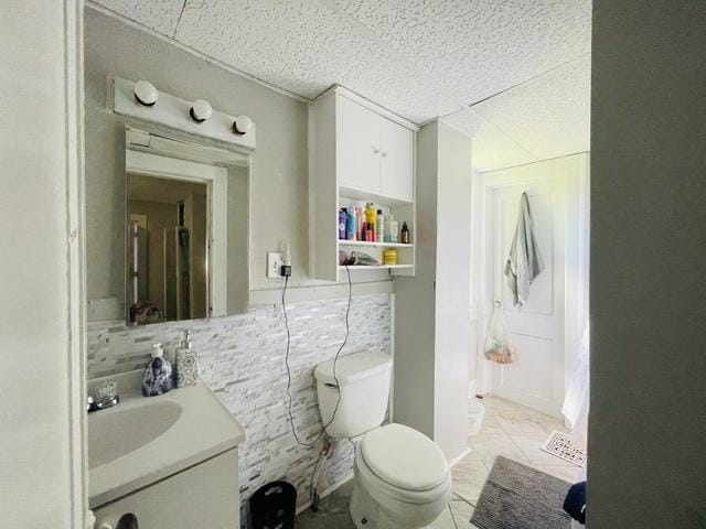 307 S 4th Ave, Kankakee, IL 60901 - bathroom with toilet, vanity, tile patterned floors, and backsplash