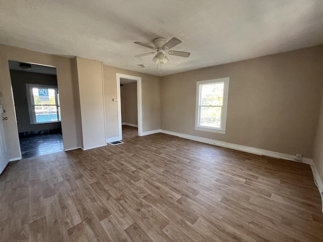 307 S 4th Ave, Kankakee, IL 60901 - empty room featuring ceiling fan, wood finished floors, baseboards, and a textured ceiling