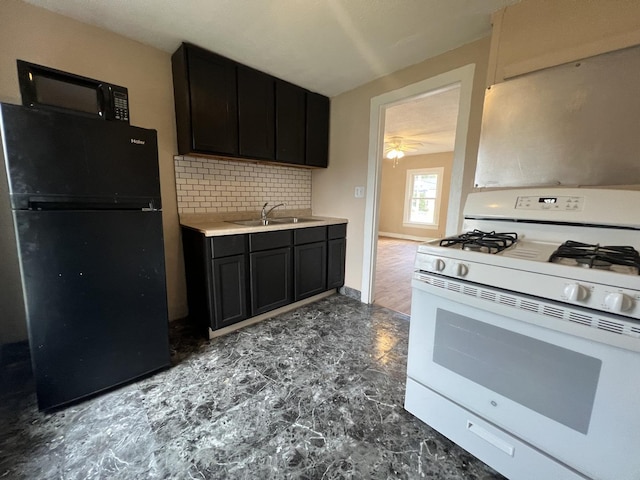 307 S 4th Ave, Kankakee, IL 60901 - kitchen with black appliances, a sink, tasteful backsplash, light countertops, and dark cabinetry