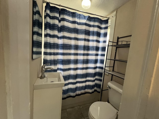 307 S 4th Ave, Kankakee, IL 60901 - full bathroom with toilet, tile patterned flooring, a textured ceiling, a sink, and shower / bath combo