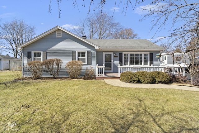 view of front of property with a front lawn and a shingled roof