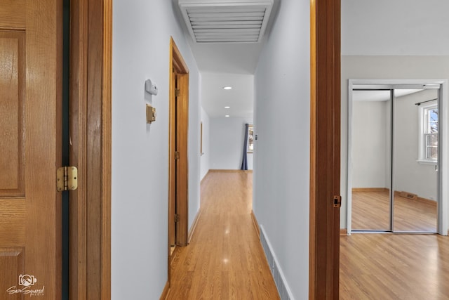 hall featuring light wood-style floors, recessed lighting, and baseboards