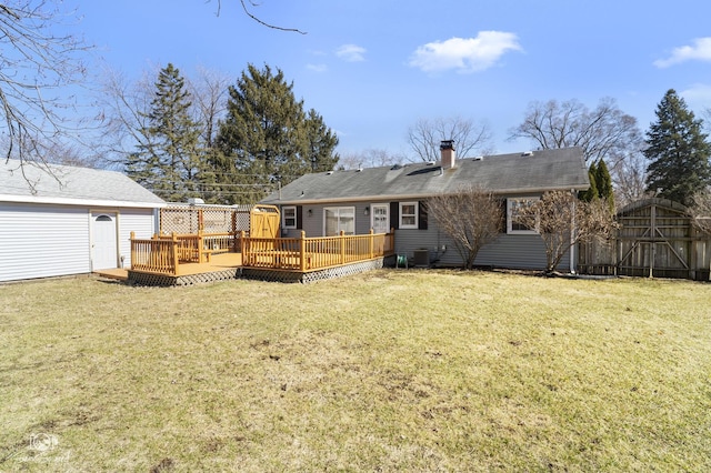 back of house featuring a deck, central air condition unit, a chimney, and an outbuilding