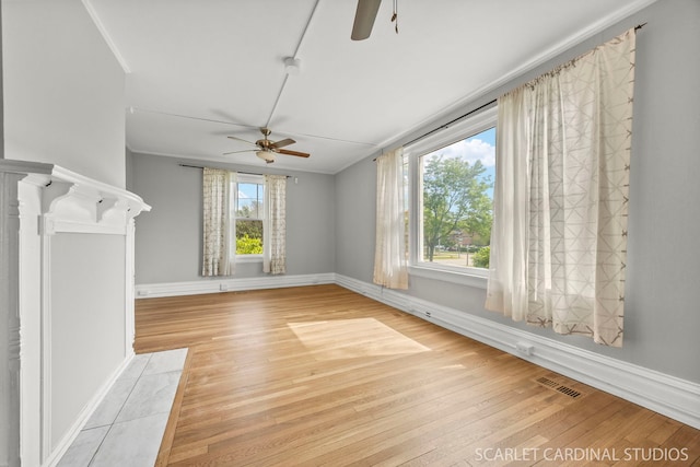 115 W Maple St, Lombard, IL 60148 - unfurnished living room featuring a ceiling fan, light wood-style flooring, and baseboards