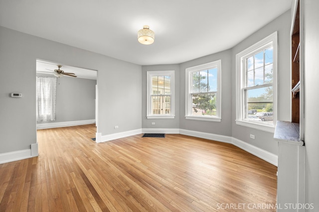 115 W Maple St, Lombard, IL 60148 - empty room with light wood finished floors, baseboards, and a ceiling fan