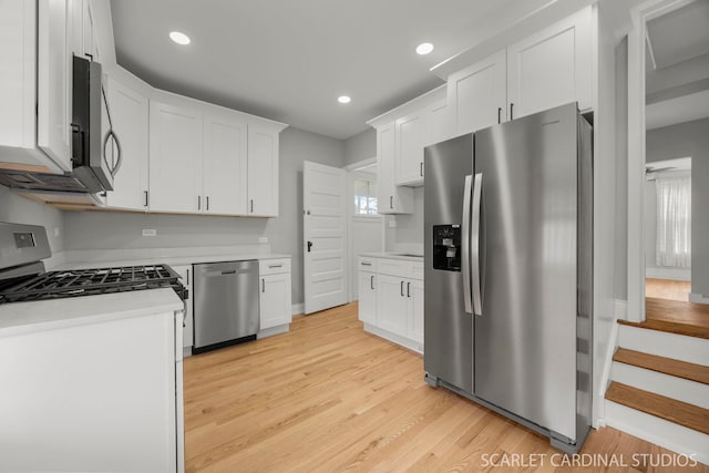 115 W Maple St, Lombard, IL 60148 - kitchen featuring appliances with stainless steel finishes, light countertops, white cabinets, light wood-type flooring, and recessed lighting