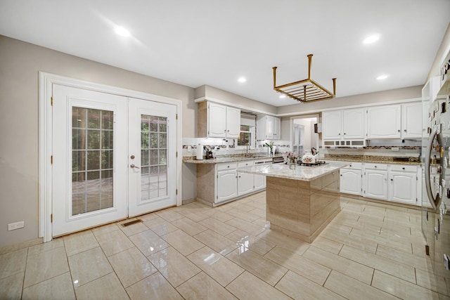 320 Brampton Ln, Arlington Heights, IL 60004 - kitchen with white cabinets, a center island, light stone counters, recessed lighting, and french doors