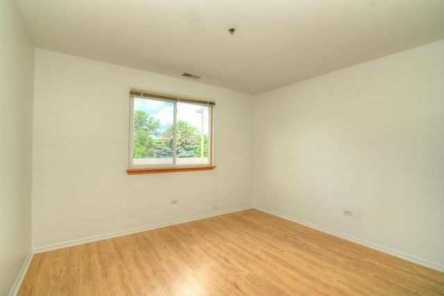 empty room with light wood-style floors and baseboards